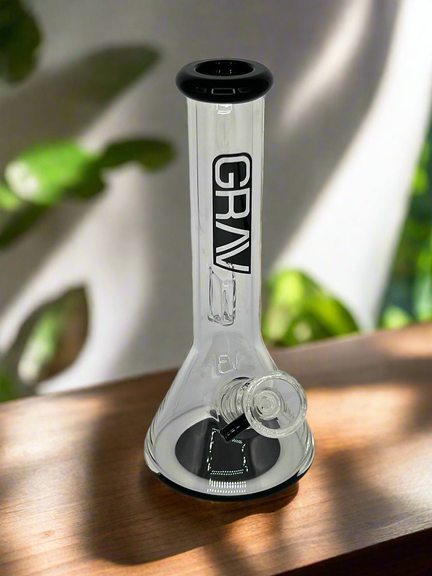 Glass smoking device with 'GRAV' branding on a gray background